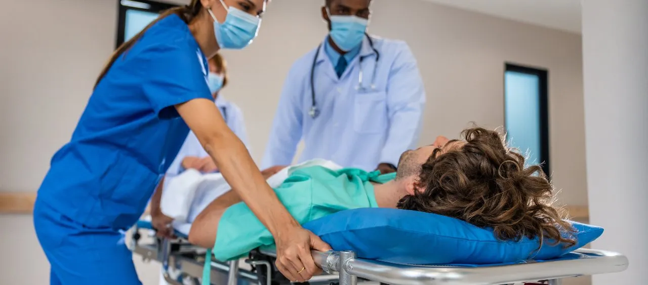 picture of nurses assisting a doctor to save a patient